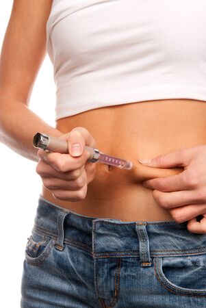 First type diabetes patient doing subcutaneous injection by single use syringe with needle and  long-acting lantus lispro insulin in abdomen by doctor prescription isolated on a white backgroundの写真素材