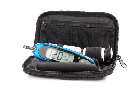 Diabetes glucose level blood test using ultra mini glucometer kit and small drop of blood from finger and test strips isolated on a white background. Device shows 120  mg/dL which is normal の写真素材