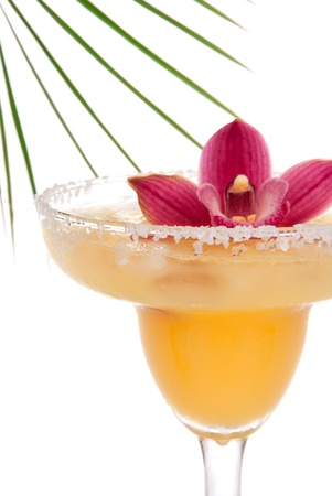Margarita cocktail drink vertical close up composition with pink orchid flower and tropical palm decoration の写真素材