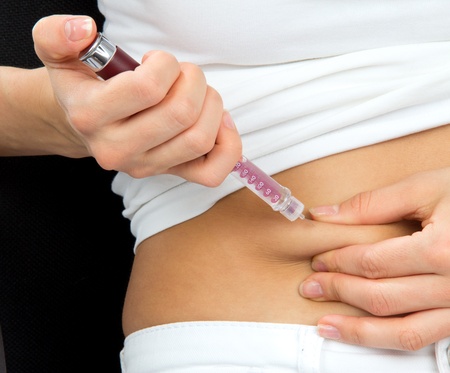 Insulin dependent Diabetes patient make a subcutaneous injection by single use syringe with needle and  insulin into abdomen by doctor prescription の写真素材