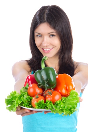 Young woman with plate of fresh healthy vegetarian vegetables salad, peppers, tomatoes isolated on a white background の写真素材