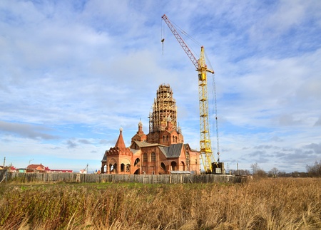 New church construction using tower crane on a siteの写真素材
