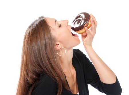 Woman enjoy donut. Unhealthy junk food concept isolated on a white backgroundの写真素材