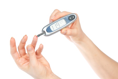 Diabetes composition glucometer in hand for measuring glucose level blood test isolated on a white backgroundの写真素材