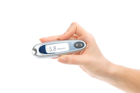 Diabetes composition glucometer in hand for measuring glucose level blood test isolated on a white backgroundの写真素材
