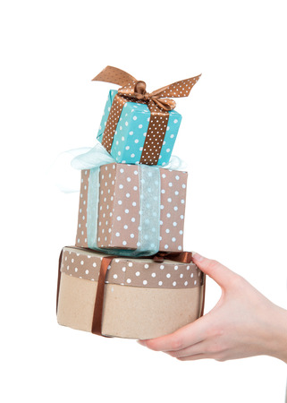 Hand with gift boxes in woman hand for christmas or birthday present on white backgroundの写真素材