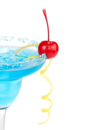 Blue Margarita cocktail drink with lemon twist in chilled salt rimmed glass with tequila, orange syrup, fresh mint, crushed ice in cocktails glass isolated on white backgroundの写真素材