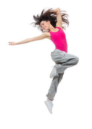 New pretty modern slim hip-hop style dancer teenage girl jumping dancing isolated on a white studio backgroundの写真素材