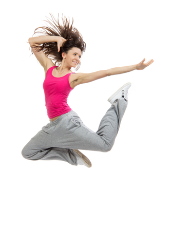 New pretty modern slim hip-hop style dancer teenage girl jumping dancing isolated on a white studio backgroundの写真素材