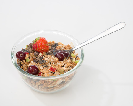Muesli cereals bowl and spoon with fruits and nuts