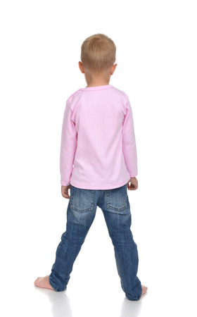 Rear view of caucasian full body american baby boy kid in pink sweater and jeans standing isolated on a white backgroundの写真素材