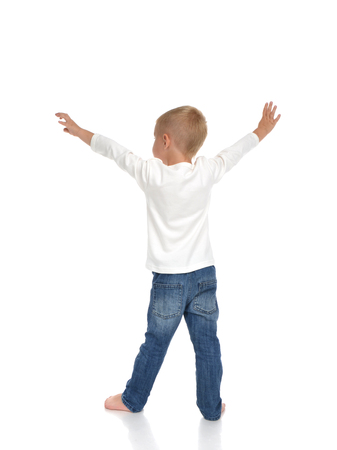 Rear view of caucasian full body american baby boy kid with arms open feeling freedom and happiness standing isolated on a white backgroundの写真素材