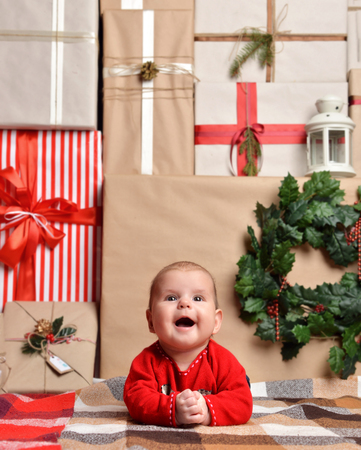 Christmas infant baby child lying rustic craft decoration gift presents boxes background. New Year 2016 holiday conceptの写真素材