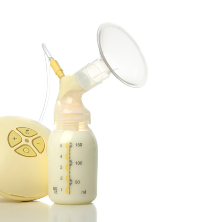 New compact electric breast pump to increase milk supply for breastfeeding mother and bags of frozen breastmilk isolated on white backgroundの写真素材