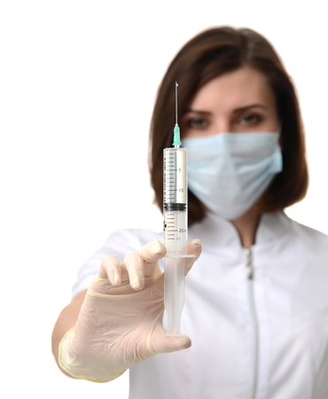 Doctor or nurse with syringe needle for flu injection vaccination concept against white backgroundの写真素材