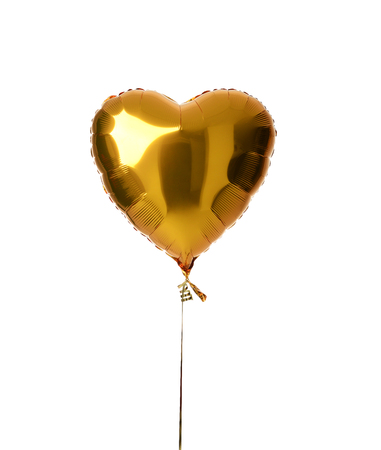 Single big gold heart metallic balloon for birthday party isolated on a white backgroundの写真素材