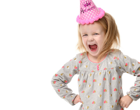 Young girl kid surprised shout in birthday party pink cap isolated on a white backgroundの写真素材