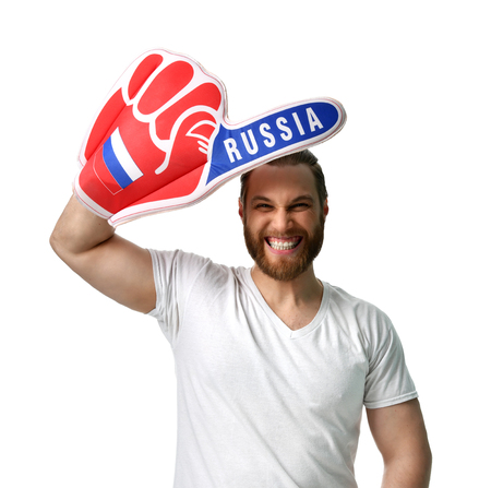 Happy man soccer fan wearing number one Russian foam finger smiling celebrating isolated on white backgroundの写真素材