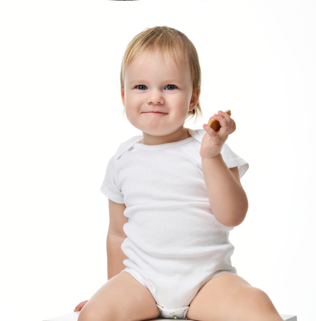 Infant child baby boy toddler sitting in polo shirt isolated on a white backgroundの写真素材