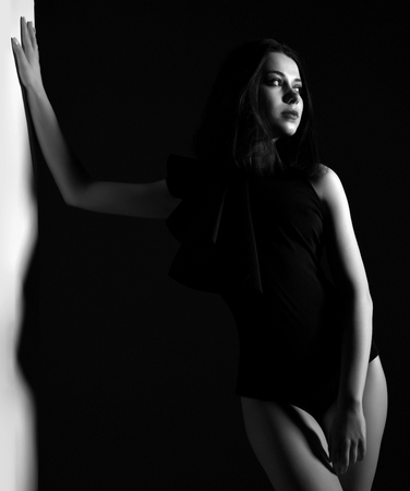 Young happy beautiful sexy woman posing  in summer fashion body vest with dramatic light black and white photoの写真素材