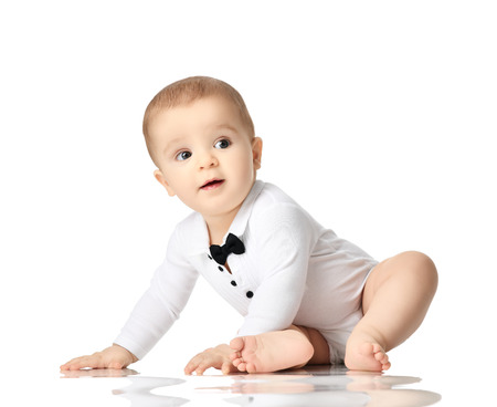 7 month infant child baby boy kid toddler sitting in white shirt isolated on a white backgroundの写真素材