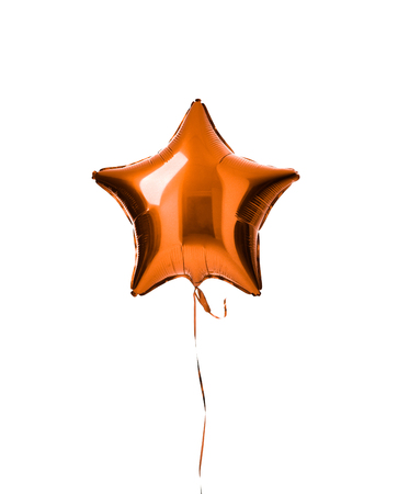 Single light orange color metallic star balloon object for birthday party isolated on a white backgroundの写真素材