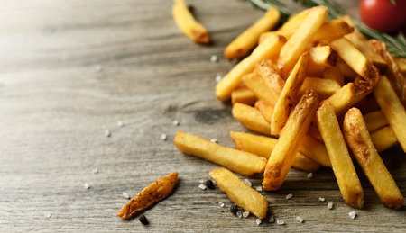 French fries chips meal with on wood background. Unhealthy weight loss diet concept.の写真素材