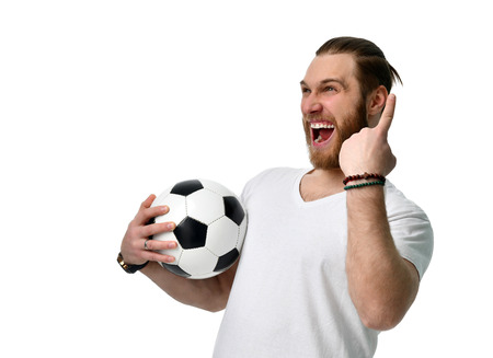 Happy man soccer fan with ball show number one winning finger smiling celebrating isolated on white backgroundの写真素材