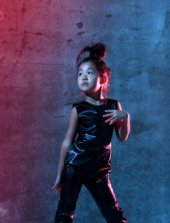 High Fashion asian model girl in colorful bright neon uv blue and purple lights colorful make up. Glitter Vivid neon lightの写真素材