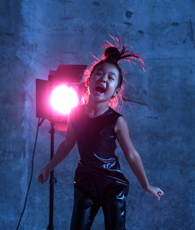 High Fashion asian model girl in colorful bright neon uv blue and purple lights colorful make up....