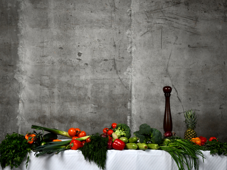 Healthy food ingredients vegetables, fruits herbs and spices. Organic vegetables on table and concrete wall backgroundの写真素材