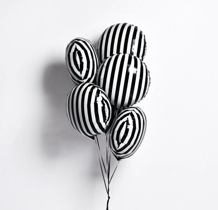 Bunch of big black and white with stripes balloons object for birthday party on gray backgroundの写真素材