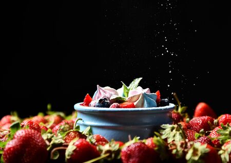 Strawberry and mint desert of fresh ripe  homemade yogurt pana cotta in blue jar on dark background. Healthy food conceptの写真素材