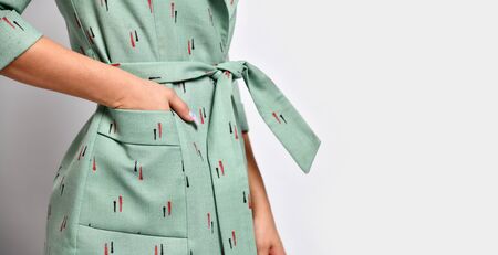 Closeup details of woman casual office suit jacket green bow knot on grey background