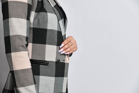 Closeup details of woman casual office suit jacket green bow knot on grey backgroundの写真素材