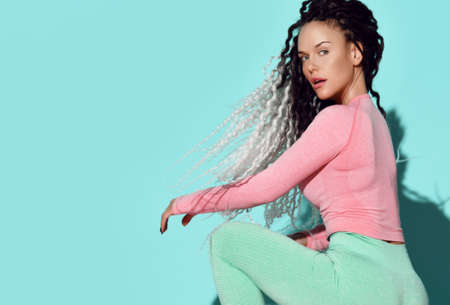 Portrait of young curvy woman with dreadlocks hairstyle in sexy sportswearの写真素材