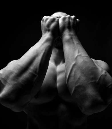 Portrait of strong bodybuilder showing tight arms and chest after fitness working out training. Black and whiteの写真素材