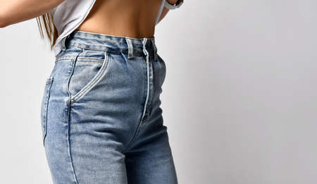 Woman showing her slim waist closeup.の写真素材