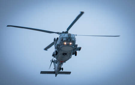 US NAVY helicopter in flight on blue skyのeditorial素材