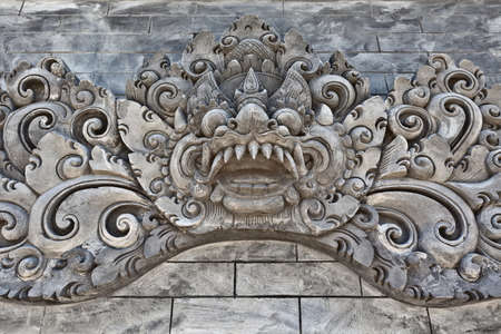 Traditional guard demon on the wall of the hindu temple. Bali.の写真素材