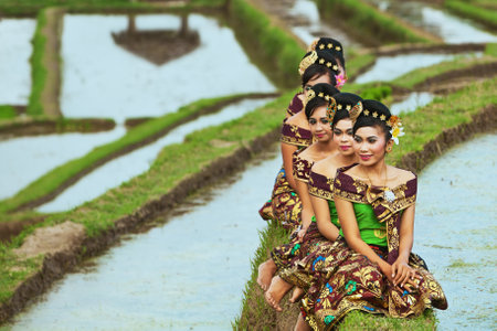 BALI INDONESIA  JULY 29: Portrait of unidentified Balinese girls on the green field with typical faces of Indonesian people wearing in traditional clothes in Jatiluwih rice terraces on 29 July 2012のeditorial素材