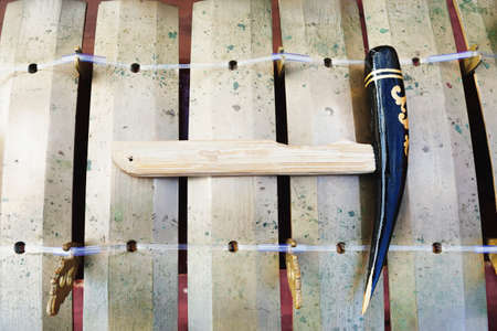Traditional Balinese musical percussion instrument - brass xylophone Jegog with hammer, part of...