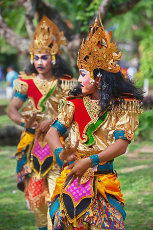 BALI ISLAND, INDONESIA - JUNE 20, 2015: Group of young men dressed in colorful ethnic Balinese...