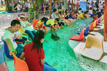 Ho Chi Minh city ( Saigon ), Vietnam - September 02, 2015: People have feet fish massage in children water park and historical theme amusement park Suoi Tien - popular travel destination in Vietnam.のeditorial素材
