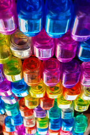 Restaurant interior background with narrow focus. Colorful rows of intage style empty transparent beverage glasses hanging on top rack above bar counter.の写真素材