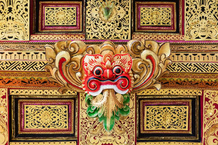 Traditional Barong mask pattern in temple - protective spirit, Bali island symbol. Featured in Balinese dances and ceremonies. Culture, religion, arts festivals of Indonesian people. Travel backgroundの写真素材