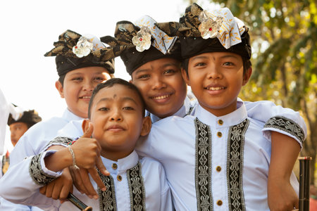 Denpasar, Bali island, Indonesia - June 10, 2017:  Group of Balinese children. Beautiful young dancers in traditional costumes on street parade at art and culture festival.のeditorial素材
