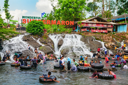 East Java, Indonesia - July 11, 2018: Sumber Maron - natural spring water spa with waterfall and swimming pools. Popular place to visit for family holidays day tour. Travel destination in Malangのeditorial素材