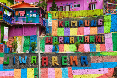 Malang, Indonesia - July 12, 2018: Colorful signboard at entrance to Kampung Warna Warni ( Jodipan village ) Popular place for city walking tour on family holidays. Travel destination in East Javaのeditorial素材