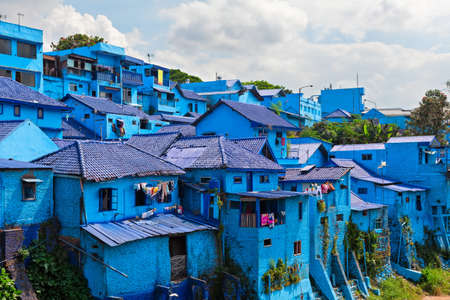 Panoramic view of village with old houses painted in blue color. Popular place to visit for city tour on family holidays. Travel destination in Malang, East Java, Indonesiaの写真素材